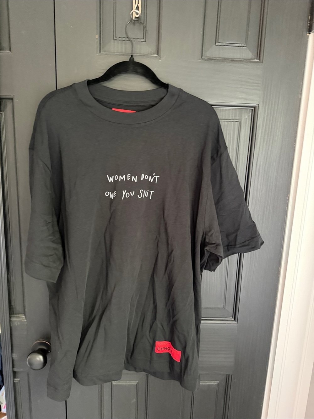 CHNGE Black Short-Sleeve Graphic Tee with White Text and Red Patch